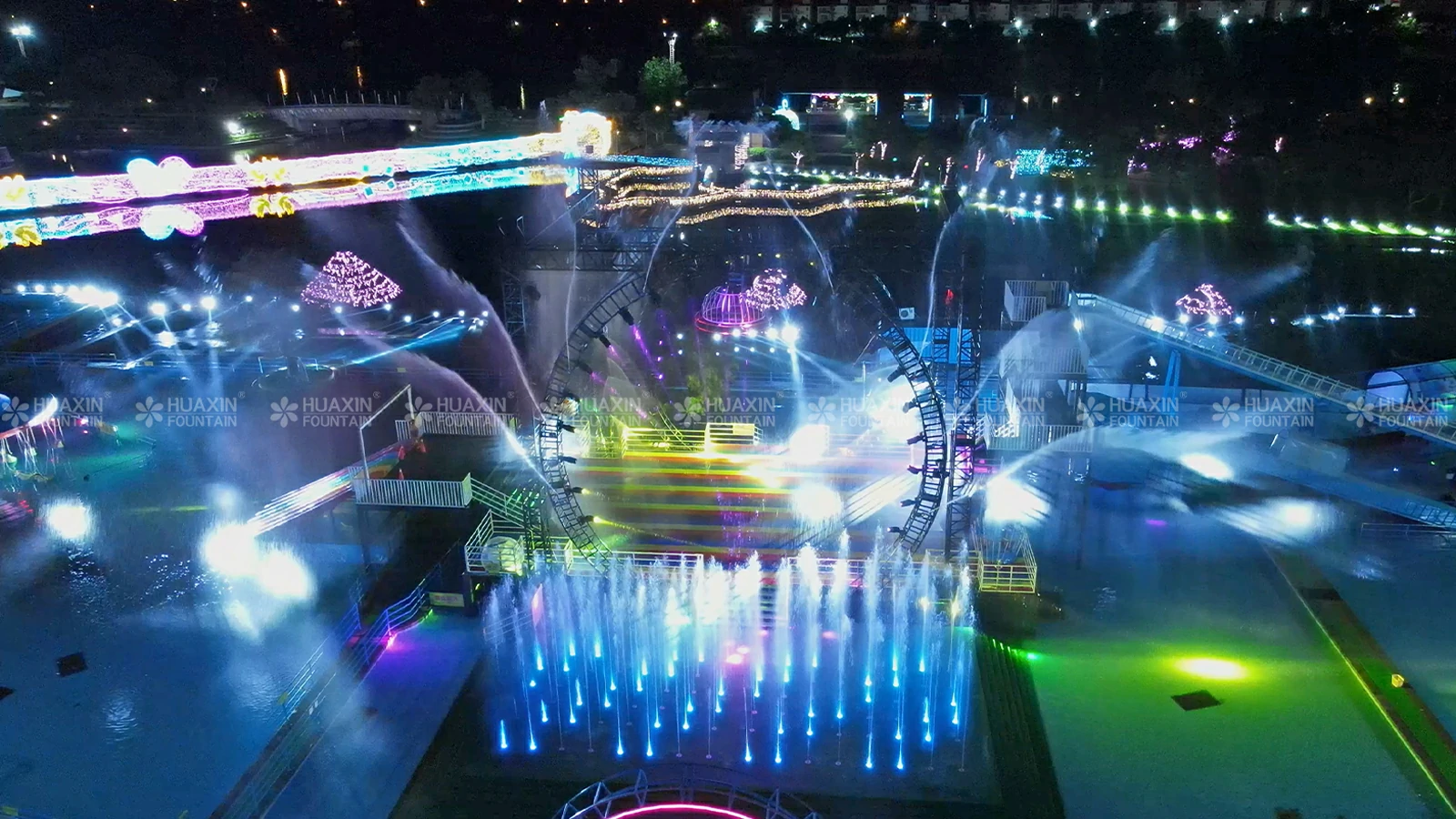 Multimedia water show combining fountain effects, lighting, laser, and water screen projection