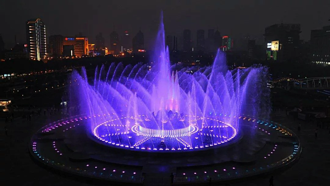 Musical fountain show synchronized with music, lighting, and programmed water effects