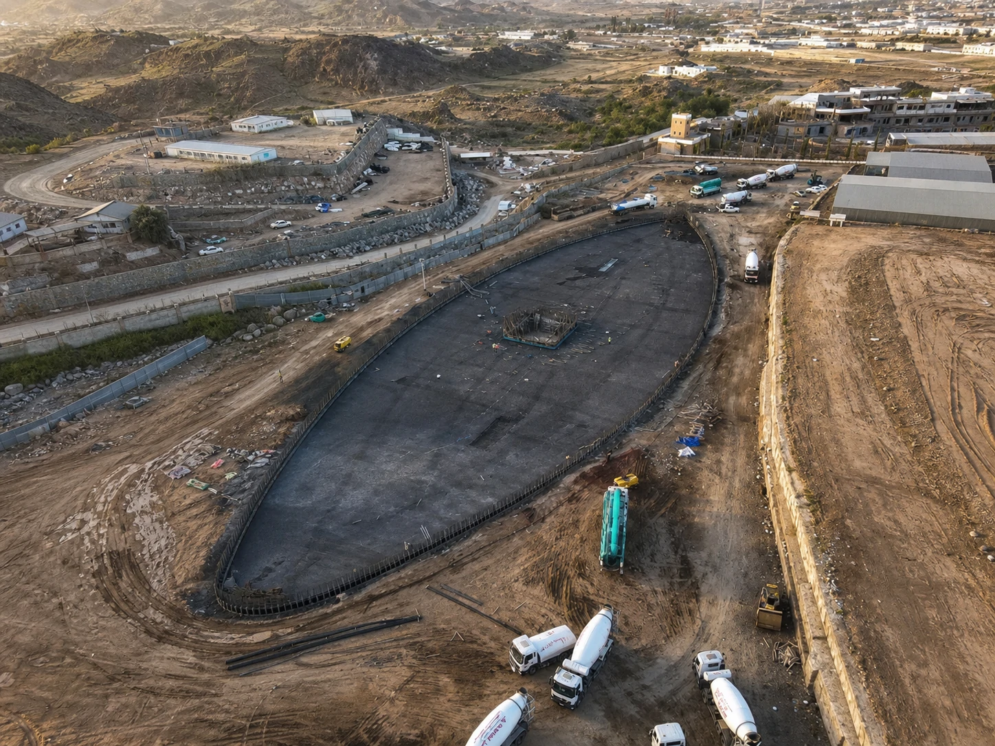 Drone view of the 160-meter spindle-shaped dancing fountain pool under construction in Abha, Saudi Arabia
