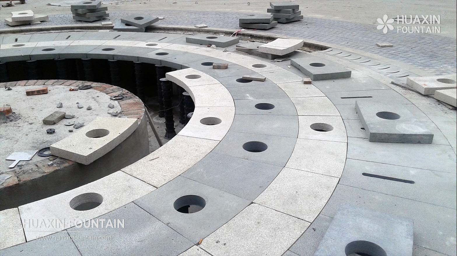 Ground-level fountain nozzles installed flush with a dry deck fountain surface