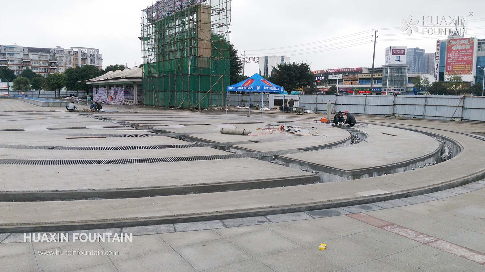 Dry deck fountain construction showing drainage equipment layout and below-deck system coordination