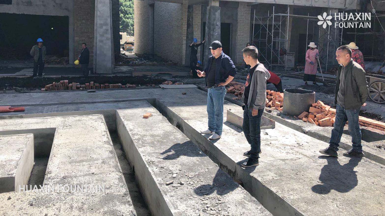 Engineers reviewing site for a dry deck fountain project