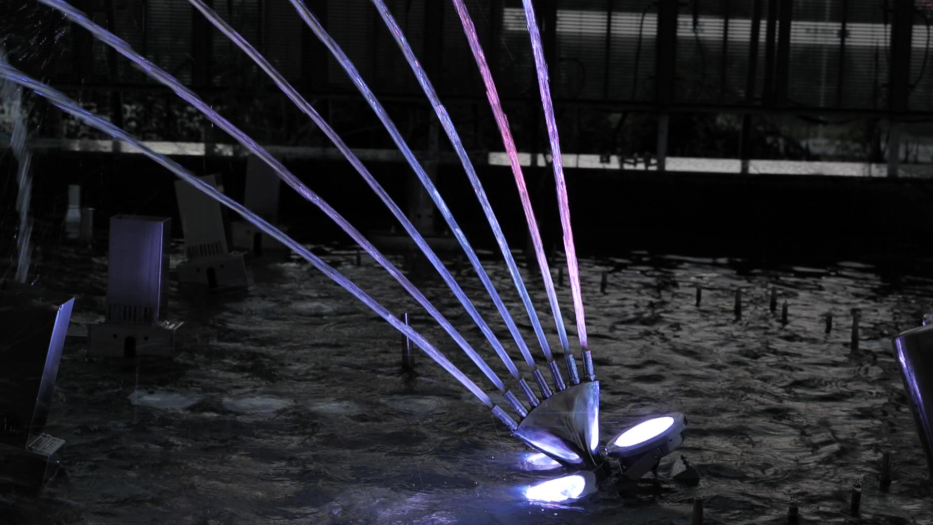 Multiple distinct water streams arranged in a fan-shaped pattern, produced by a Huaxin finger jet fountain nozzle.