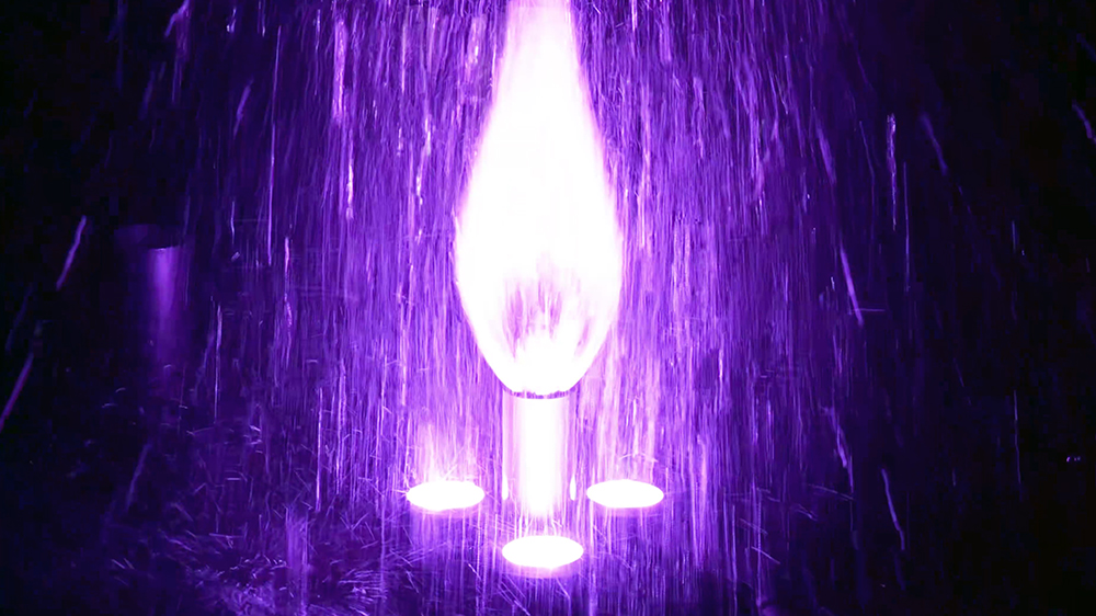 Close-up of water flowing from a Huaxin integrated variable fountain nozzle operating in a pool