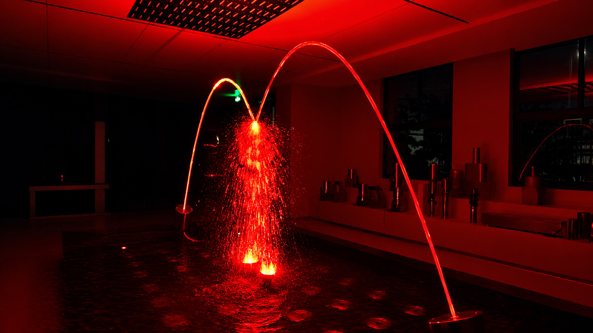 Water arcs and landing positions of Huaxin jumping fountain jets in a pool